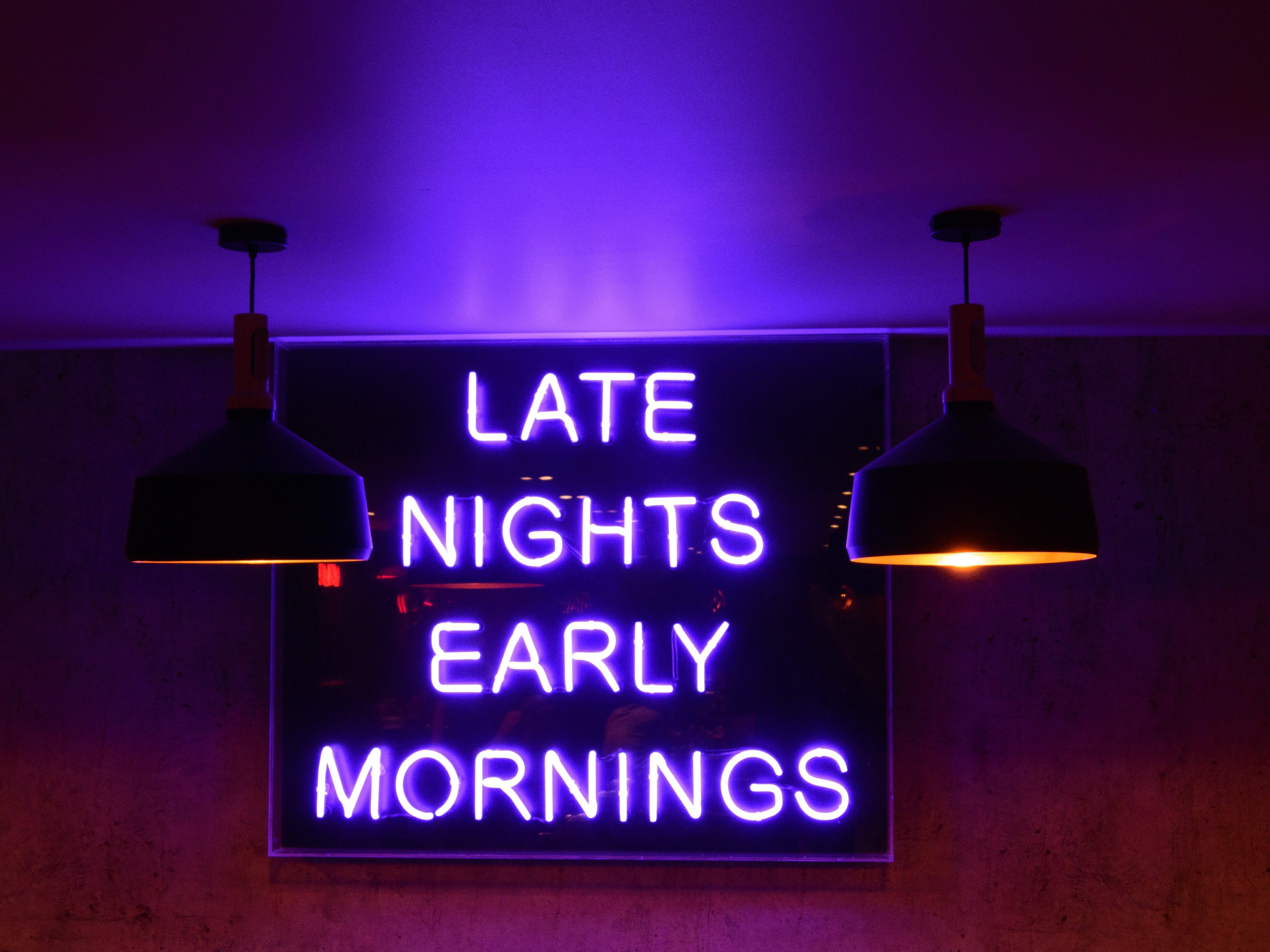 Neon sign with the text “Late Nights, Early Mornings”