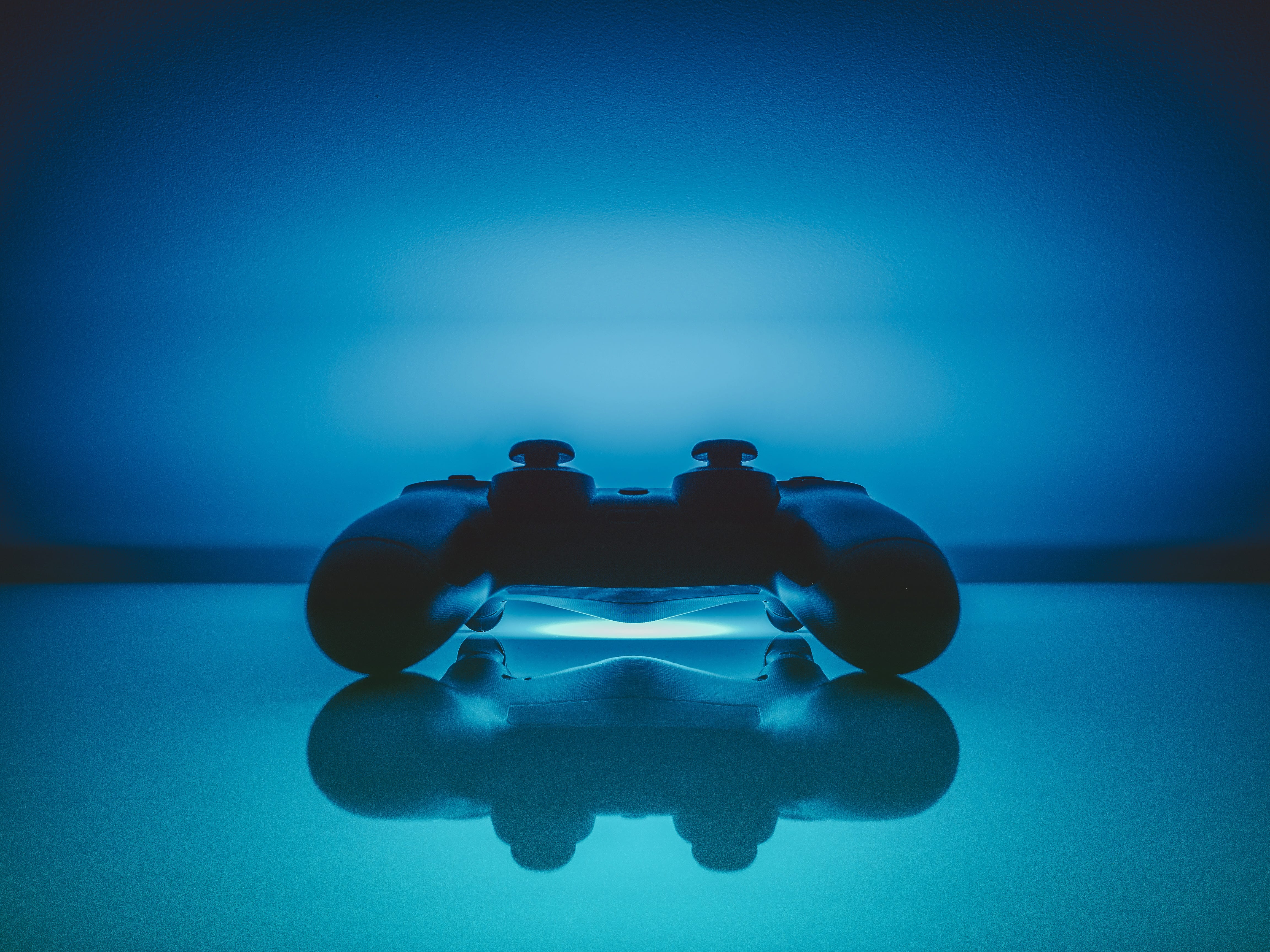 A video gaming controller with an interesting blue background.