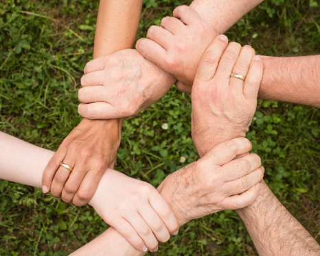 People holding hands as a sign of mutual trust