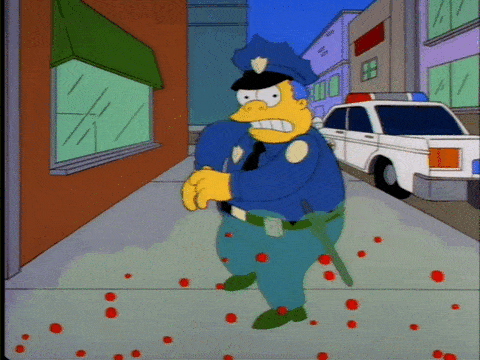 Chief Wiggum backs away screaming and shooting at a virus (The Simpsons).