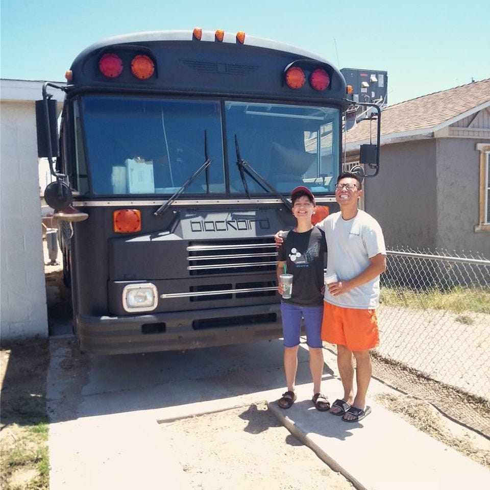 Erin, Michael Choi, and the Blackbird Bus, parked in Las Vegas at the time