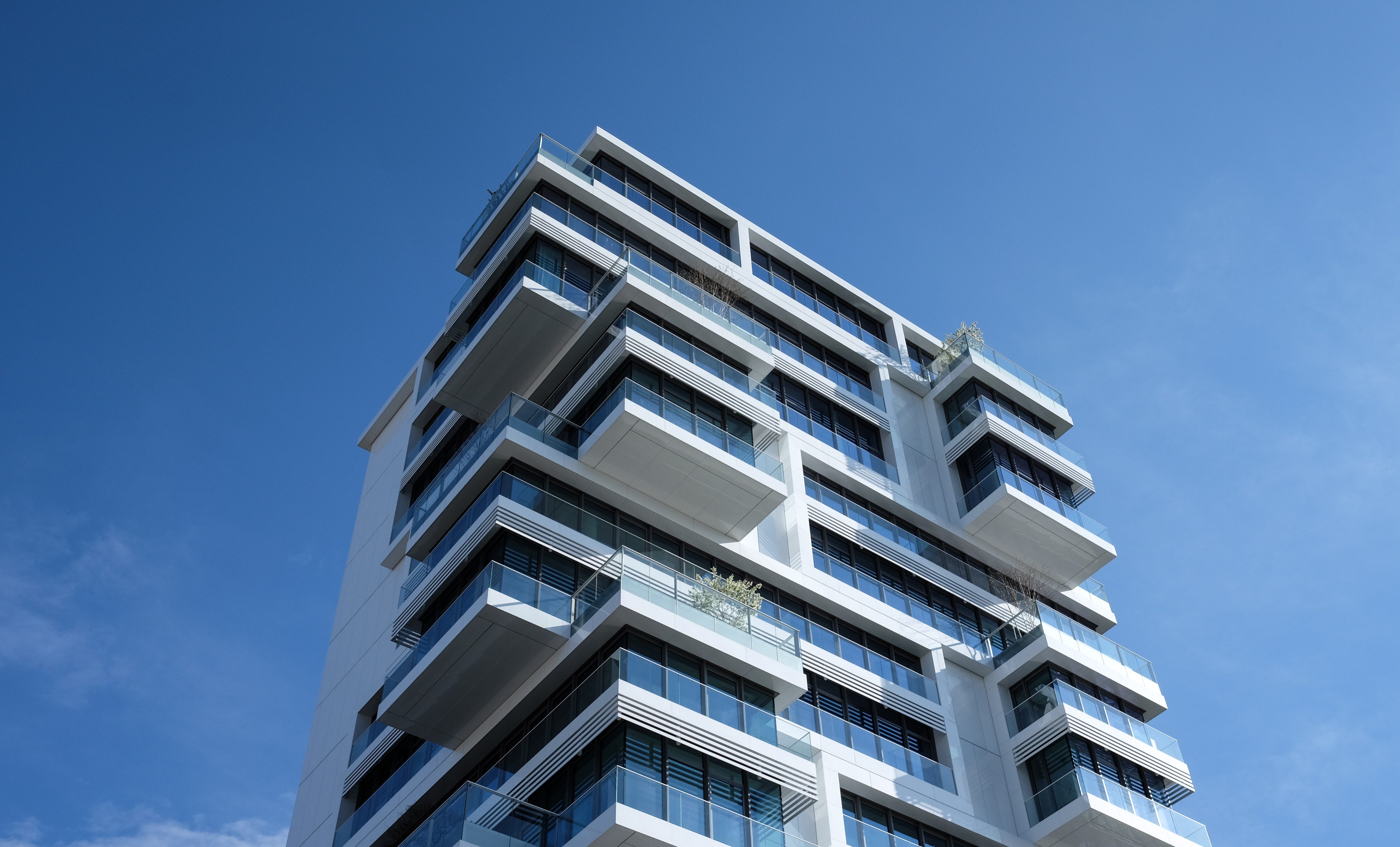 A white condo tower reaching into the sky