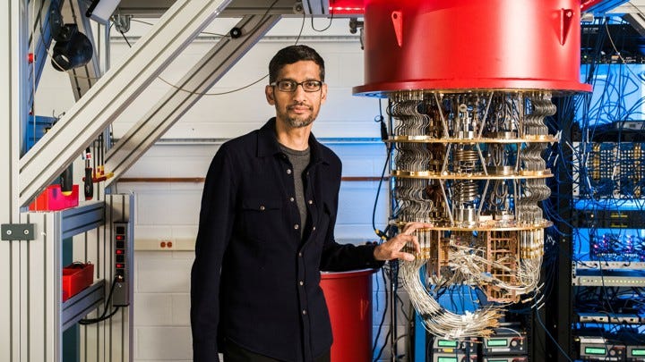 Sundar Pichai CEO of Google standing next to Google’s Quantum Computer