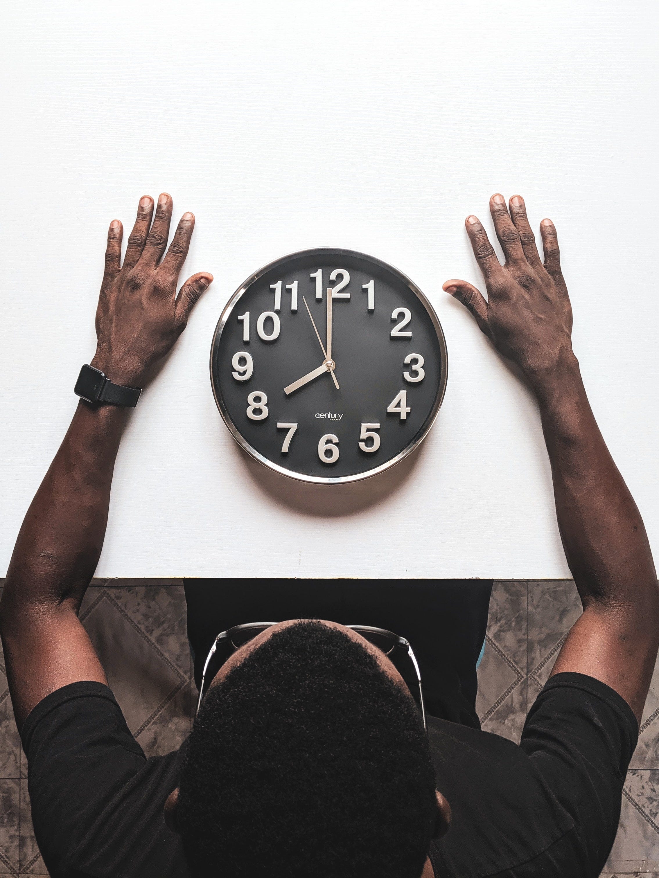 Man with a clock between his arms