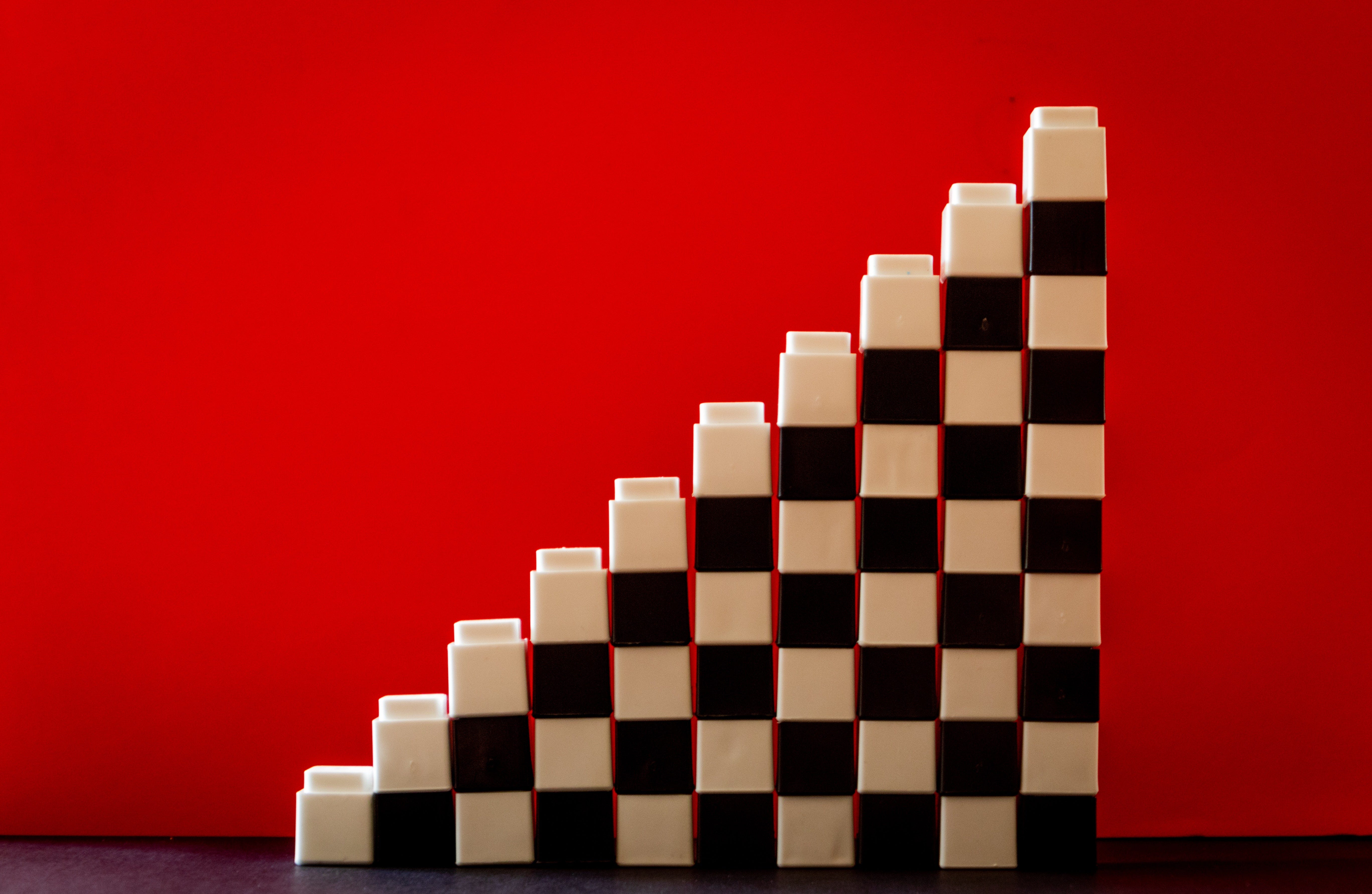 Black and white blocks are stacked on top of one another, forming stair steps.