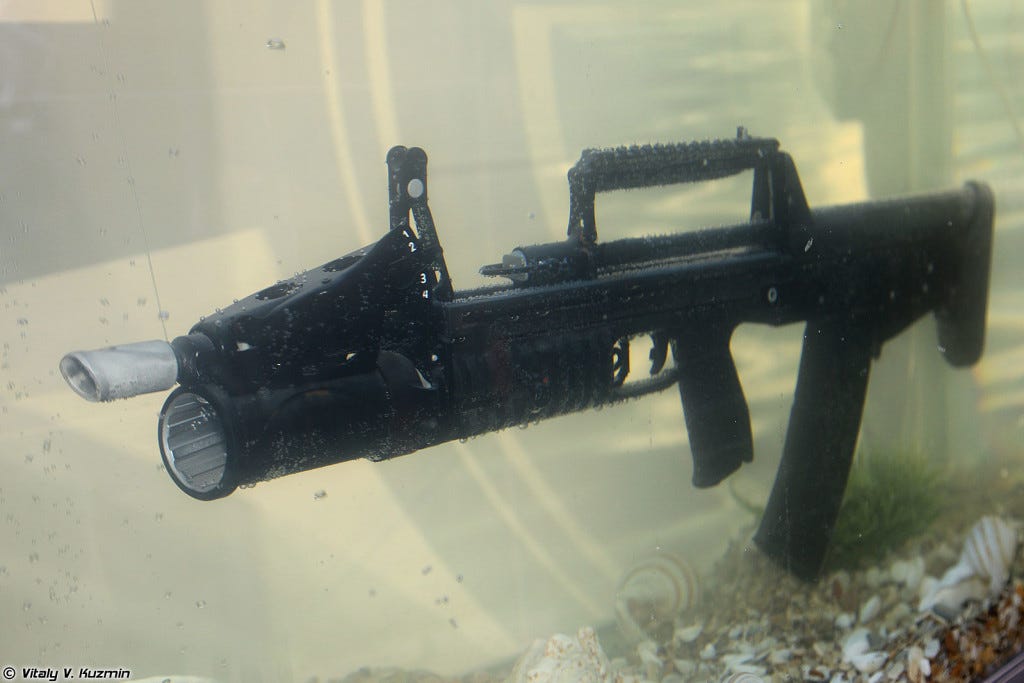 ADS amphibious assault rifle on display in an aquarium at the 2013 Interpolitex International Homeland Security Exhibition in Moscow. Photo by Vitaly V. Kuzmin courtesy of Wikimedia Commons. https://commons.wikimedia.org/wiki/File:Interpolitex_2013_(536-2).jpg