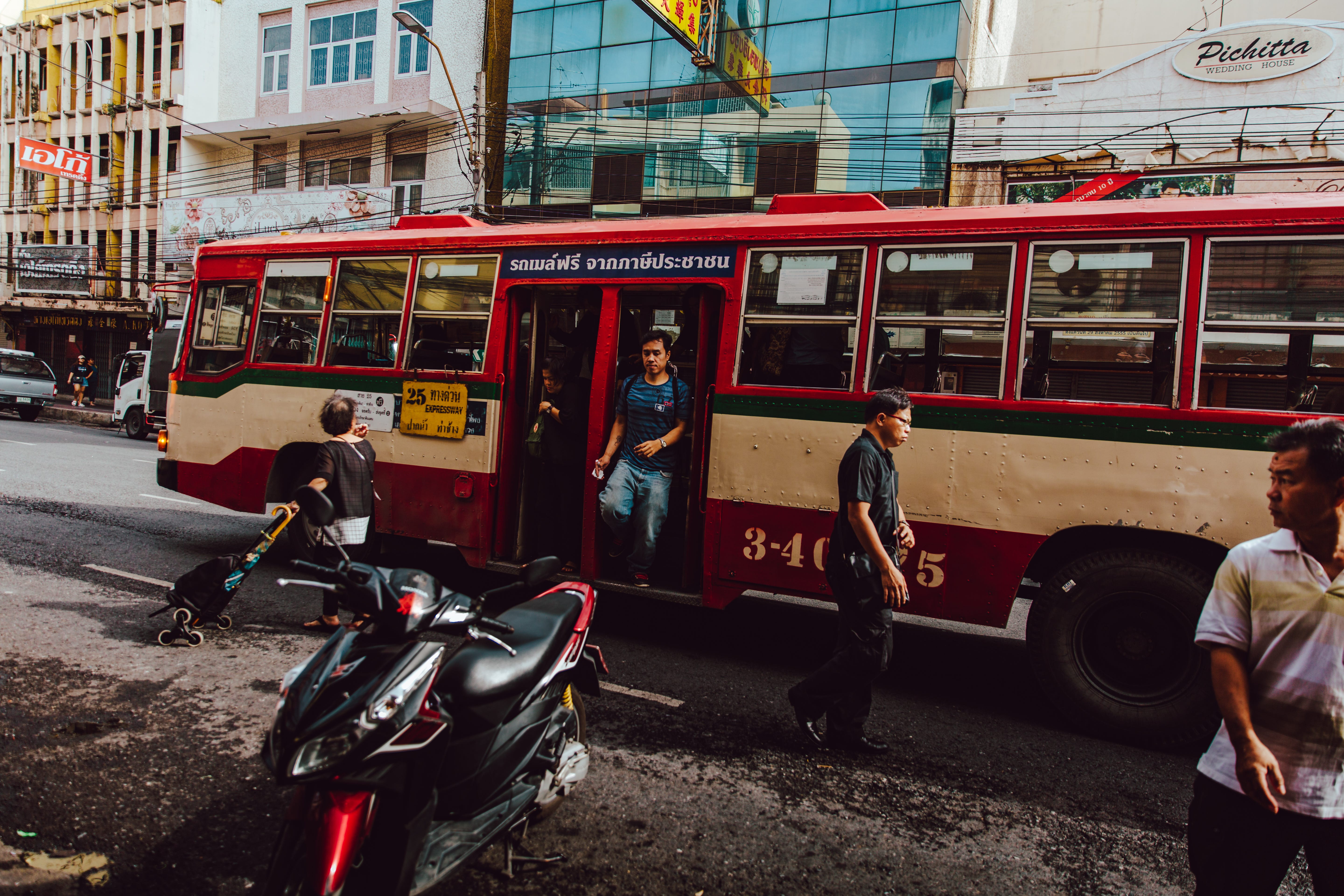 Man getting off a bus in the city.