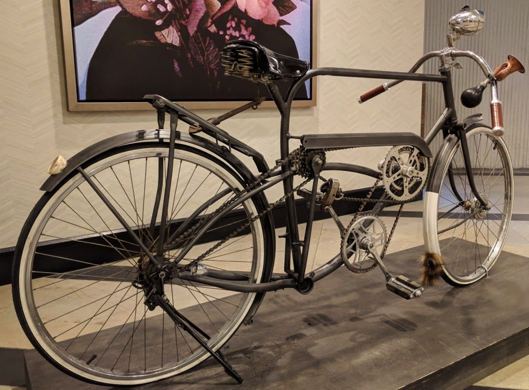A strange looking bicycle with multiple sprockets and chains.