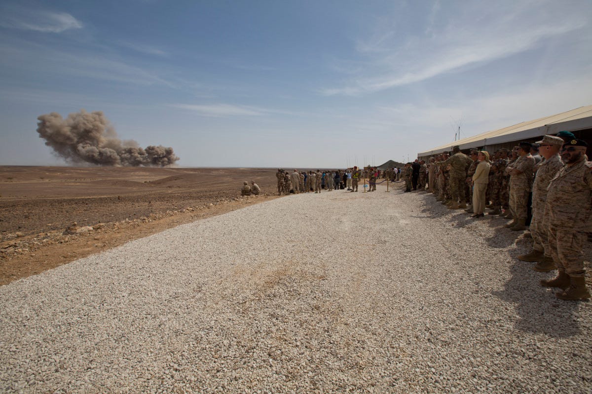 Above - American officers and other watch as B-52s pummel a training range in Jordan. Marine Corps photo. At top - a B-52 heads out for a training exercise in Norway. Air Force photo