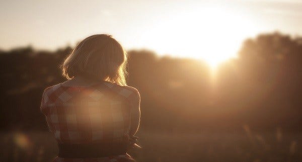Photo of a girl in silhouette with setting sun