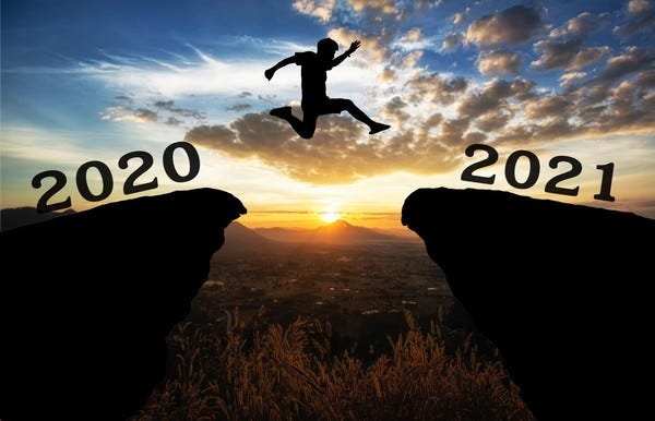 Man jumps over a clearance from one cliff to another, departing from 2020 and landing on 2021