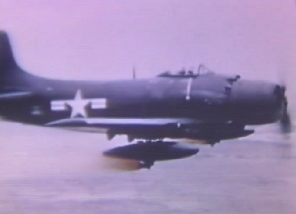 Above - U.S. Navy sailors don gas masks. At top - an AD Skyraider fitted with spray tanks. Navy photos