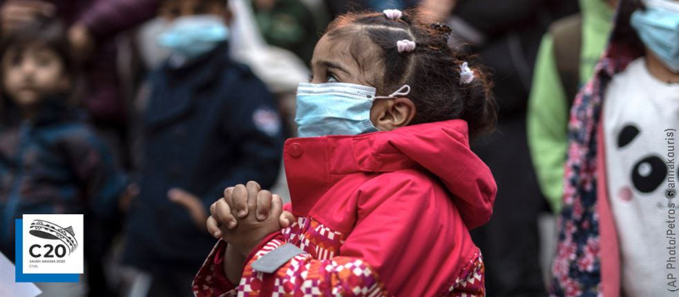 A young migrant girl, wearing a Covid-19 protection mask, is relocating from the overcrowded refugee camp on Lesbos Island to the Greek mainland, May 2020. (AP Photo/Petros Giannakouris)