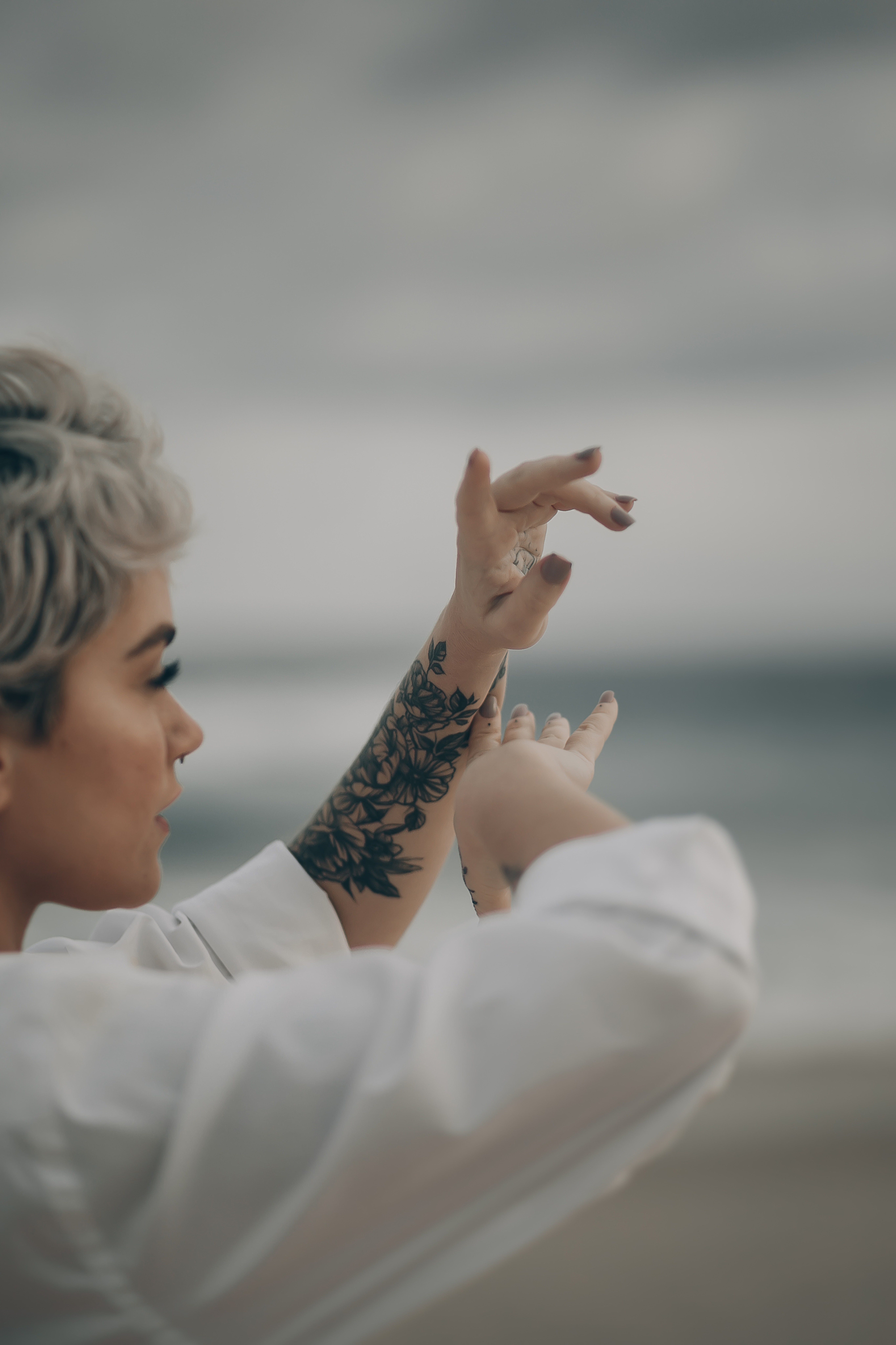 Gen X woman showing off her tattoo inked on her arm