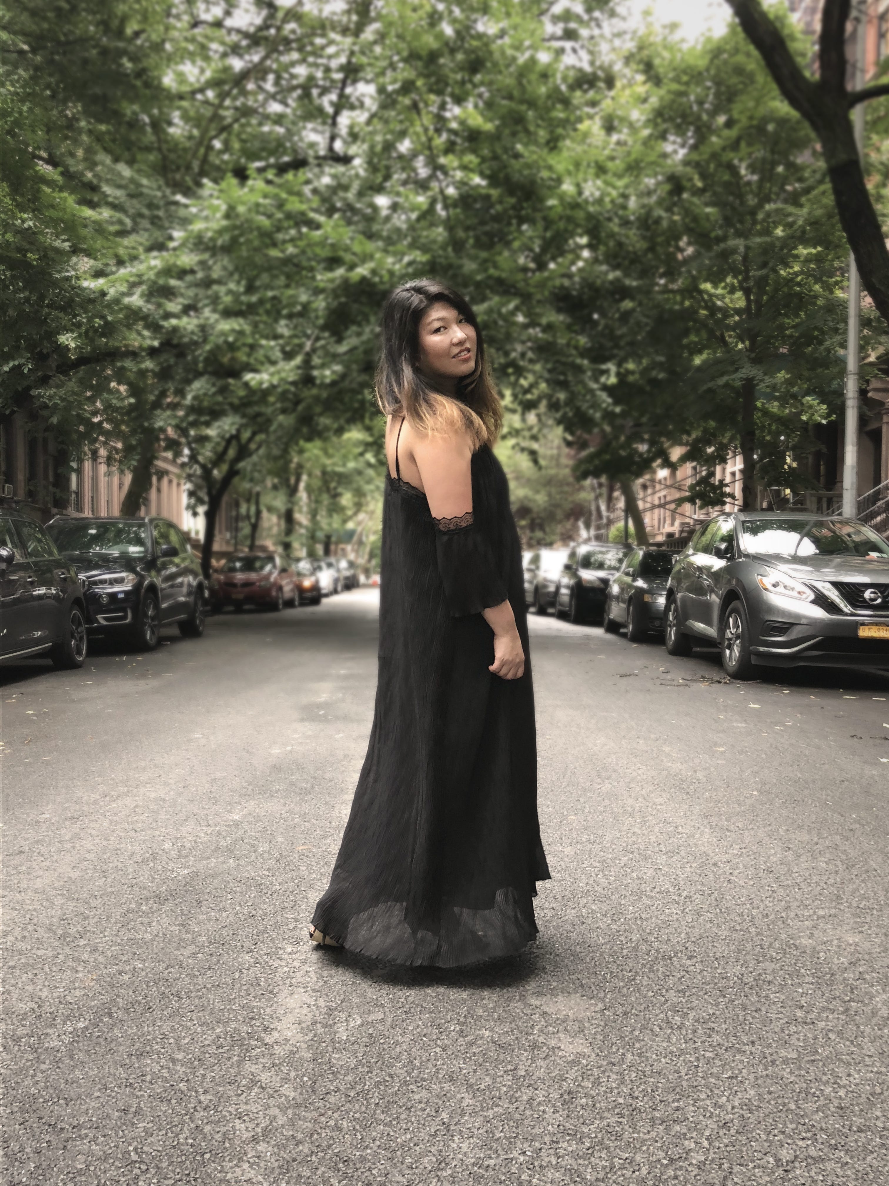 Jolene Delisle, co-founder and creative director of The Working Assembly wearing the black pleated dress by Bastet Noir