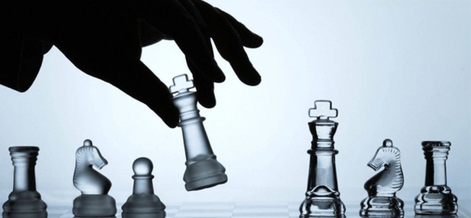 A hand moving a chess piece