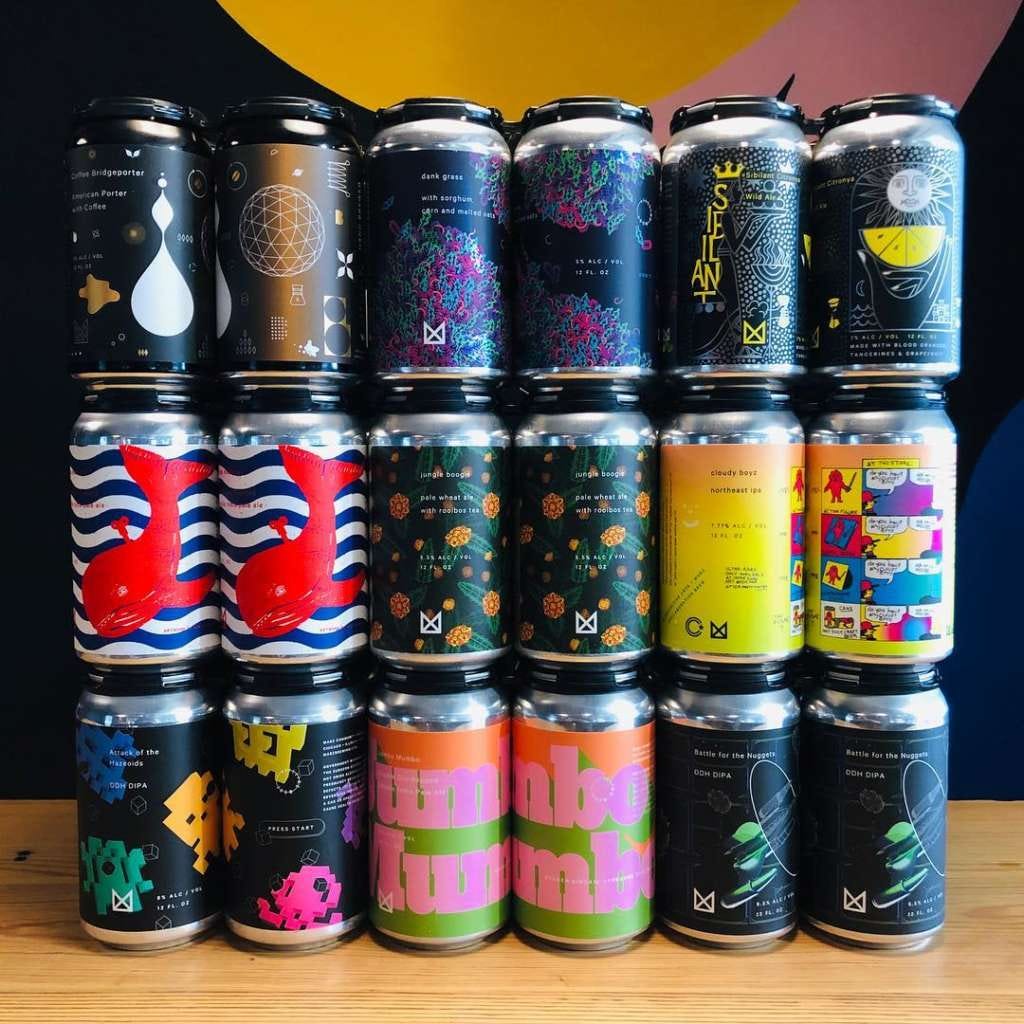 Stacked rows of colorfully designed cans of Marz Brewery craft beer