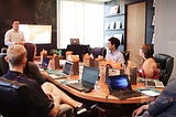 Marketers gathered around a desk planning a campaign