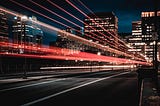 Trail of light beams from cars on a highway