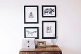 Set of four hanging pictures with black frames