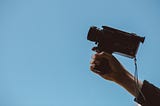 Holding video camera that’s pointed at the sky.