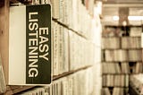 Easy listening sign in library book shelf. I’m A Good Listener But I Want To Solve Your Problem. Learning the lost art of just being there.