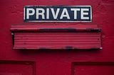 A red door saying ‘PRIVATE’