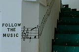 stairs going up a walkway with musical notes on the wall