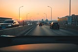 Cars on a highway. Photo by Xiaolong Wong on Unsplash