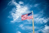 An American flag waving against the sky.