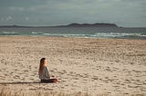 a woman meditates peacefully in the morning. we all need some mental strength in these difficult times.