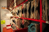 A photograph of a rack of hundreds of vinyl records