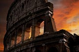 The Colosseum in Rome set against a sunset.