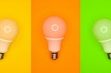 3 lightbulbs side by side, set against a yellow, orange and green background