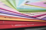 Stacks of colorful papers to represent a layering process
