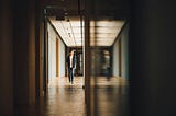 A child walking down a dark hallway.
