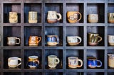Several cups in a cupboard