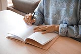 woman writing in planner