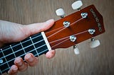 A hand holding a guitar