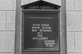 A sign outside of Trinity Church. It says: “Rich, Poor, White, Black, Gay, Straight- All Are Welcome.”