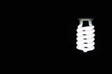 A white LED lightbulb shining in a black background