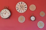 Wall with several clocks on it