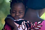 Baby asleep on mama’s shoulder