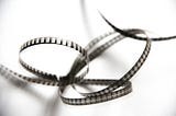 Interlocking spirals of black and white movie film.