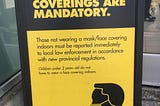 A “Masks/face coverings are mandatory,” sign at a local No Frills supermarket in Pickering, Ontario