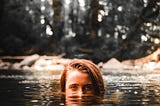 Person swimming in a creek