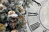 Antique clock with roman numbers and christmas greenery