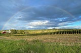 Decorative image of a farm with a rainbow