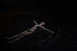 A woman floating in water.
