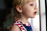 Girl-Looking-Outside-of-The-Window-With-Wishful-Eyes